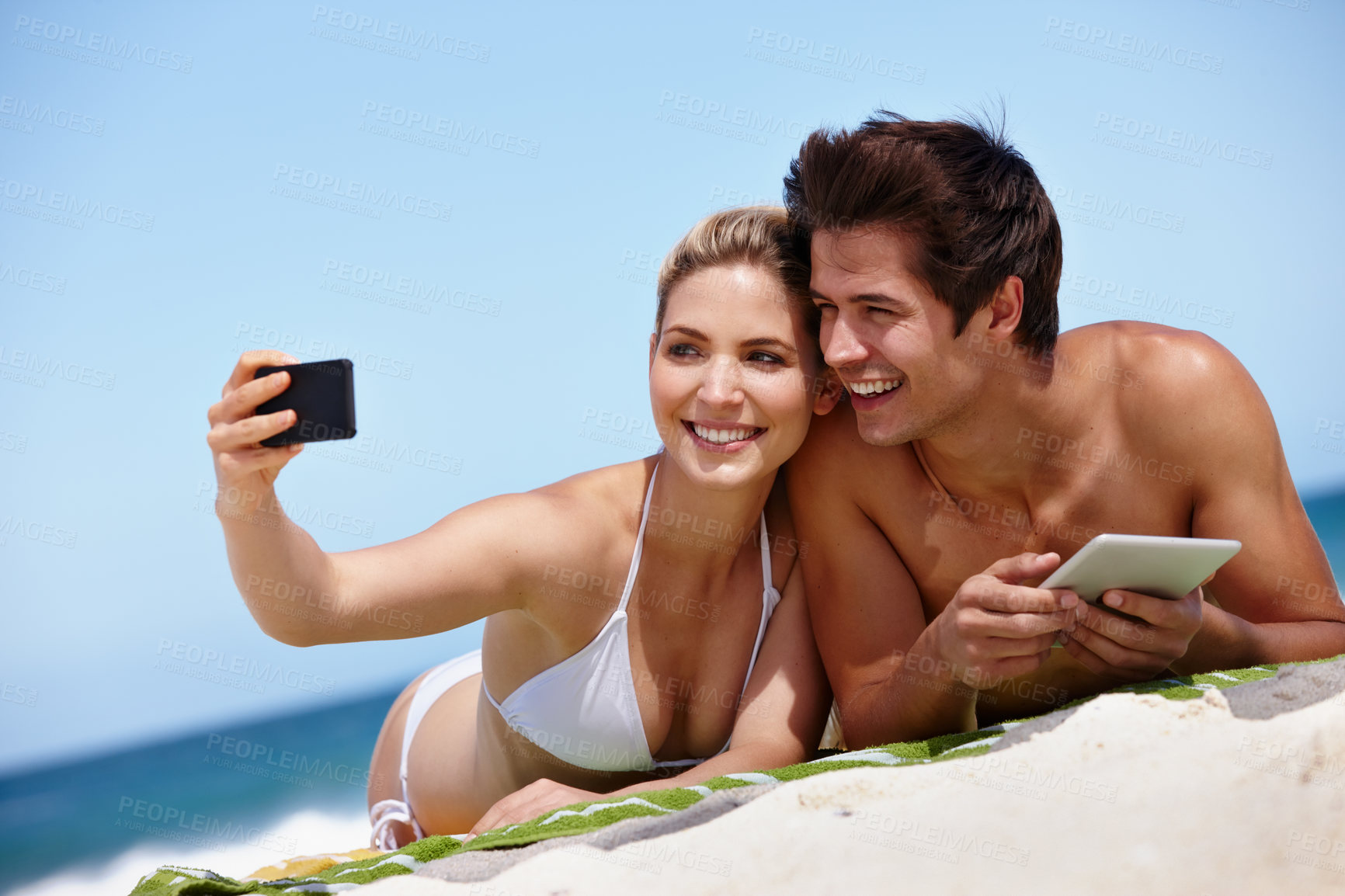 Buy stock photo Selfie, beach and bonding of couple, smile and peace for date in nature, blanket and holiday. Travel, moment and photography for memory at sea, outdoor and people in relationship, love and picture