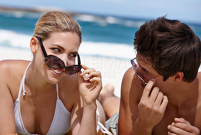 Buy stock photo Couple, playful and sunglasses on beach for travel, bonding and tropical holiday with blue sky. Man, woman and happy outdoor for fun trip, love and vacation with sunshine, relax and date on weekend