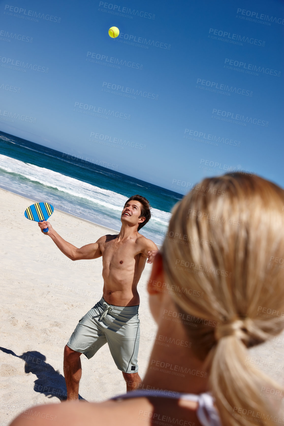 Buy stock photo Man, tennis and beach play by waves together for fun, holiday or bonding with sports and exercise in nature. Happy couple, game match and Miami ocean with vacation, adventure and travel with trip