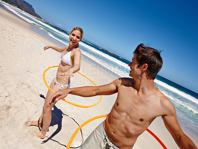 Buy stock photo People, plastic hoop and beach play by waves together for fun, holiday or bonding with core exercise in nature. Happy couple, game and Miami ocean with vacation, adventure and travel with trip