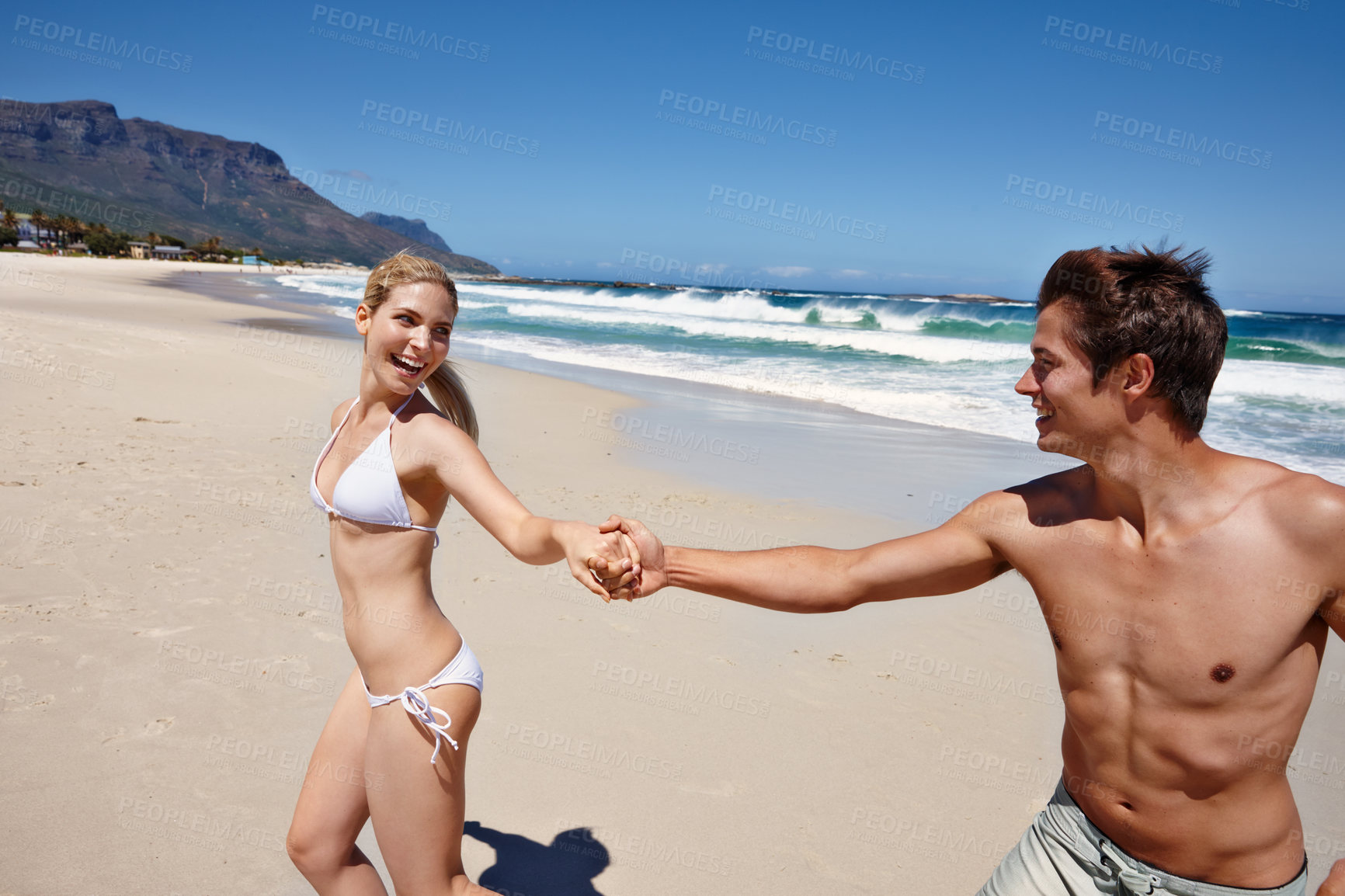 Buy stock photo Excited, beach and happy couple holding hands on holiday, summer vacation or travel. Love, man and woman at ocean for support, romantic connection or laugh for healthy relationship and walk on date