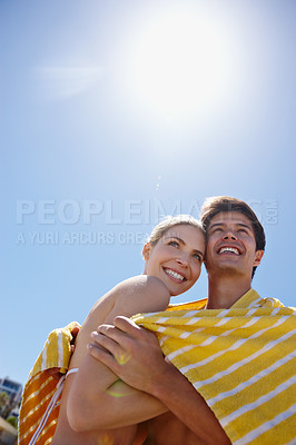 Buy stock photo Sky, towel or happy couple hug at sea with love on outdoor summer vacation, valentines day or holiday. Below, anniversary space or people at beach for bonding together on romantic date trip in Greece