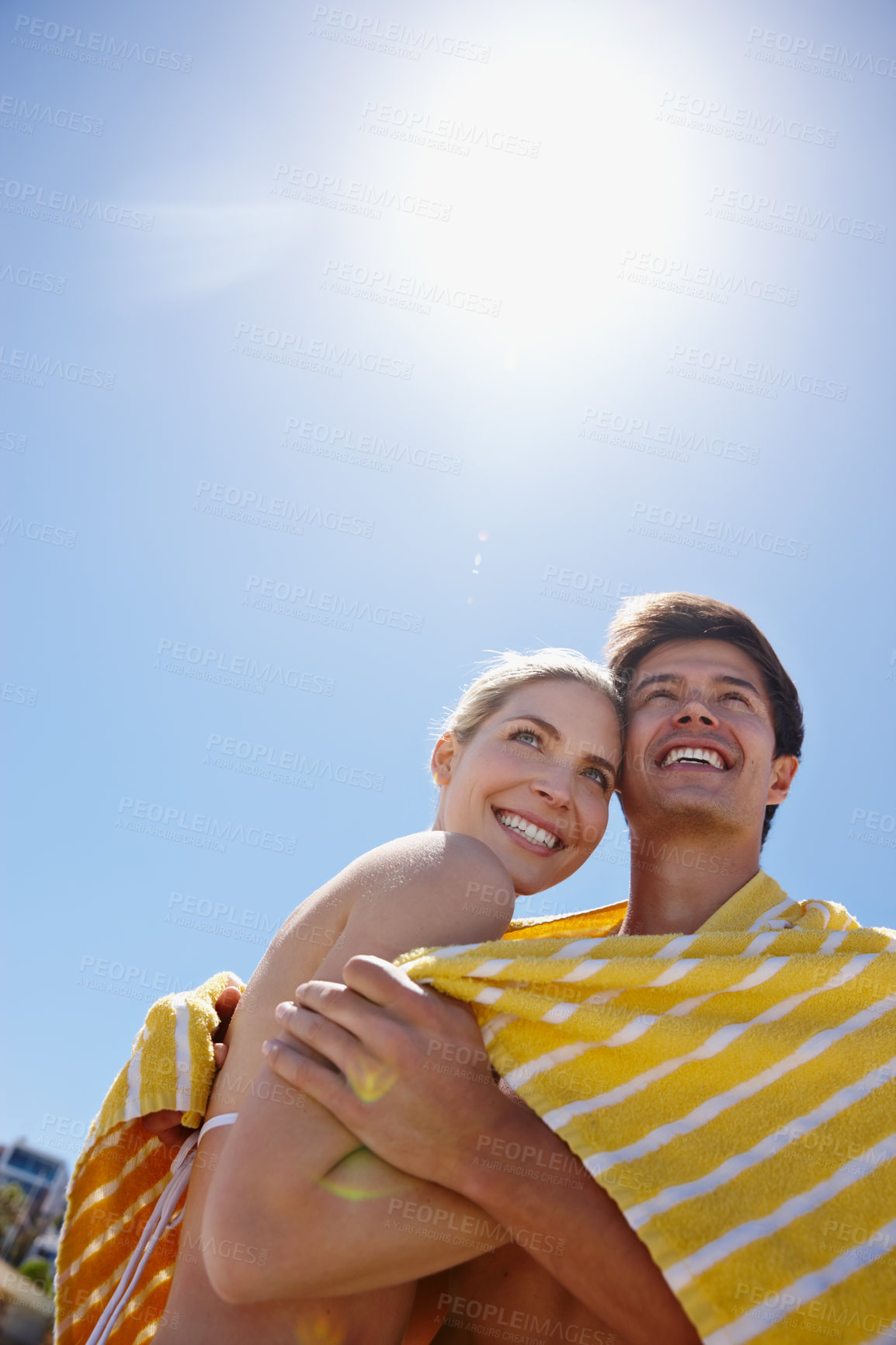 Buy stock photo Sky, towel or happy couple hug at sea with love on outdoor summer vacation, valentines day or holiday. Below, anniversary space or people at beach for bonding together on romantic date trip in Greece