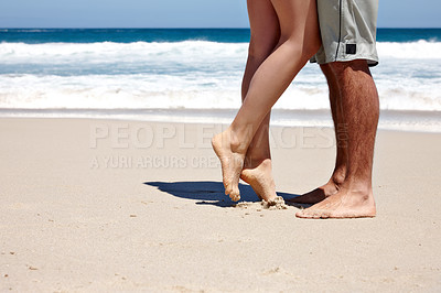Buy stock photo Cropped shot of a couple sharing a romantic moment together at the beach 