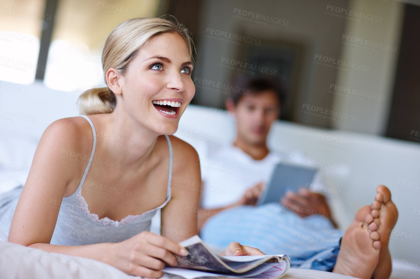 Buy stock photo Bedroom, woman and smile with magazine for reading, information and relax with happy thoughts at home. House, couple and female person with thinking for inspiration, ideas and print tips for marriage