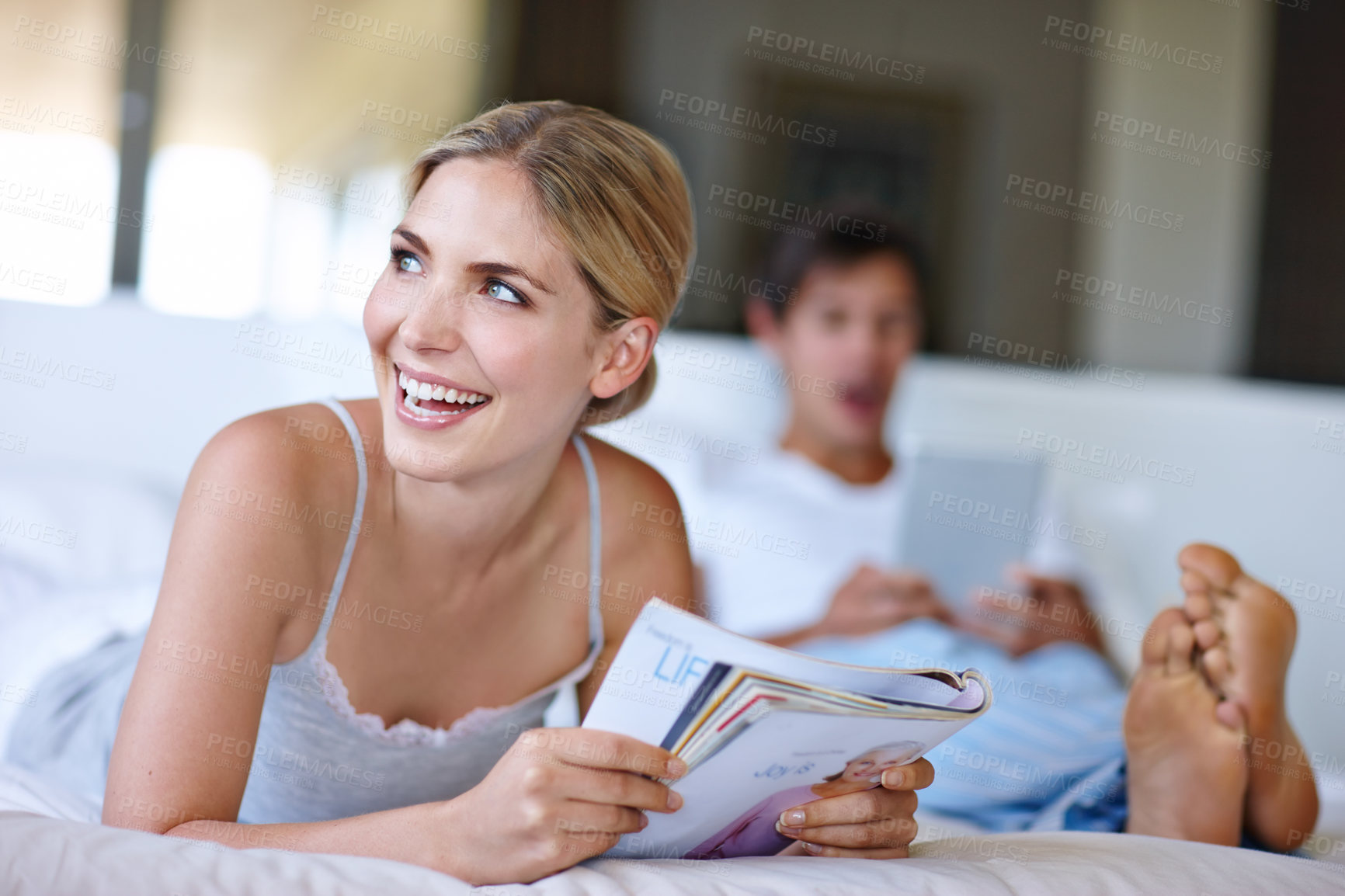 Buy stock photo Bedroom, woman and thinking with magazine for reading, information and relax with happy thoughts at home. House, couple and female person with smile for inspiration, ideas and print tips for marriage