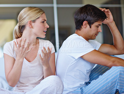 Buy stock photo Shot of a young couple having an argument at home