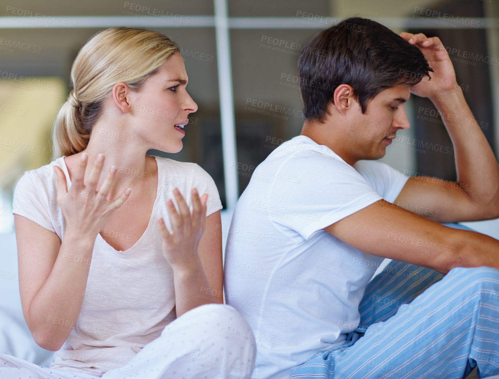 Buy stock photo Shot of a young couple having an argument at home