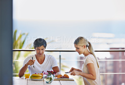 Buy stock photo Balcony, couple and smile with food for breakfast, hungry and bonding together on vacation in morning. Outdoor, man and woman with nutrition for eating, romance and commitment in dating on holiday