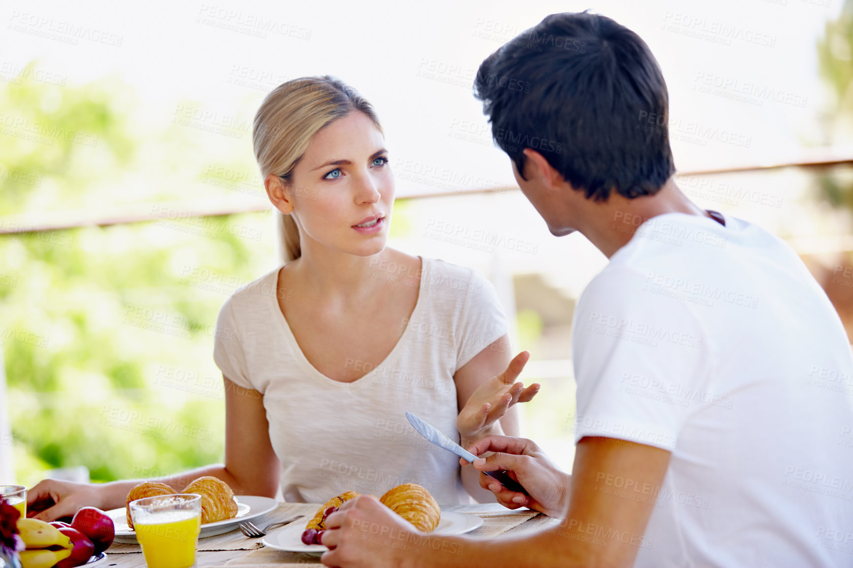 Buy stock photo Outside, home and couple at breakfast with discussion for nutrition, diet and health with love. People, relationship and conversation at patio with food on table for bonding, support and relaxing