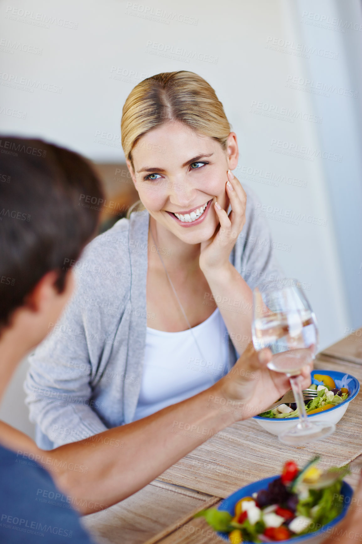 Buy stock photo Salad, couple and home with happy woman with diet, wellness and health food at dining room table. Conversation, eating and love of people together with vegetables and lunch with care and bonding