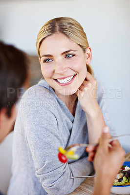 Buy stock photo Shot of a happy young couple enjoying a healthy salad together 