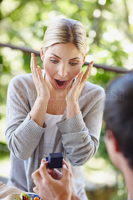 Buy stock photo Shocked, woman and couple with ring in proposal for commitment, offer and engagement question. Romance, surprise and boyfriend with jewellery in box for future, conversation and asking for marriage