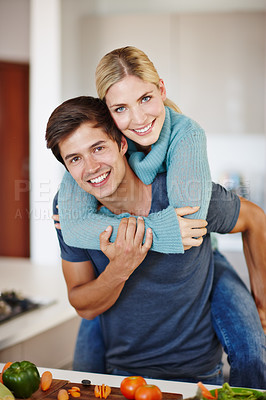 Buy stock photo Shot of a happy young couple sharing an affectionate moment together while preparing a meal