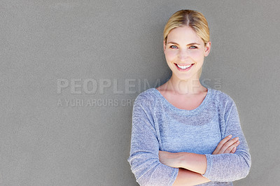 Buy stock photo Portrait of a confident young woman standing against a gray background