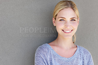 Buy stock photo Portrait of a happy young woman standing against a gray background
