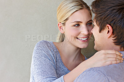 Buy stock photo Shot of an affectionate young couple standing against a gray background