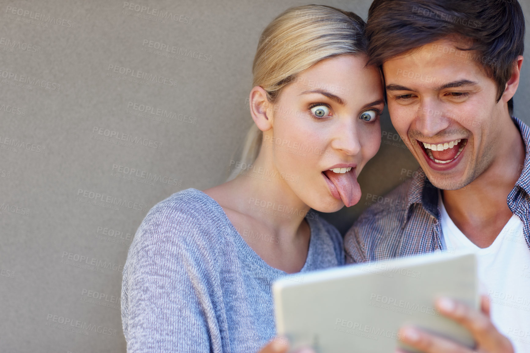 Buy stock photo Happy, selfie and couple with funny face on tablet for online chat, social media and bonding on weekend. Relax, dating and man and woman on digital tech for internet, website and picture in town