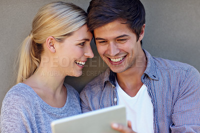 Buy stock photo Happy, gray background and couple on tablet for online chat, social media and bonding on weekend. Relax, dating and man and woman on digital tech for internet, website and networking in urban town