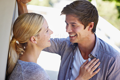Buy stock photo Shot of a young couple sharing an affectionate moment together outdoors