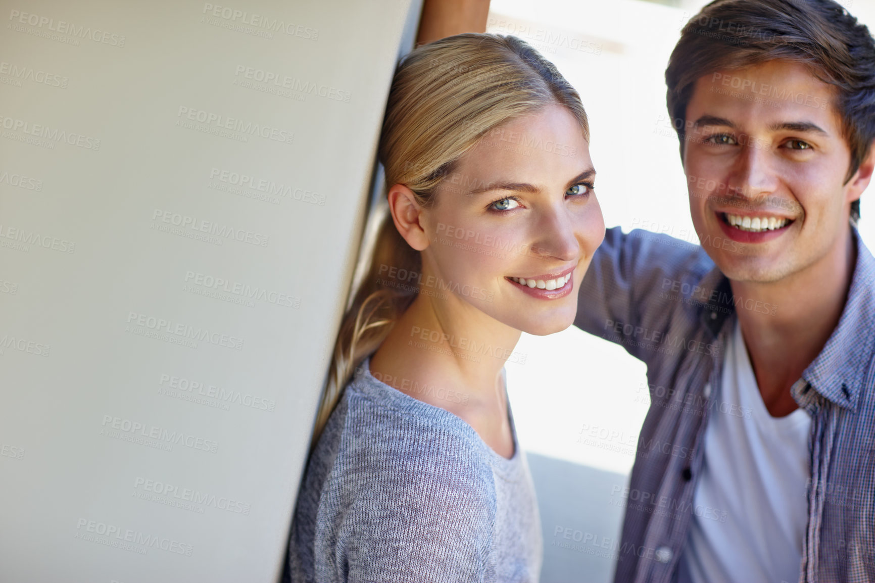 Buy stock photo Couple, face and happy on gray wall for bonding, love and relationship outdoor with support. Man woman and portrait for trust, date and romantic connection with relax, smile and mockup space outside