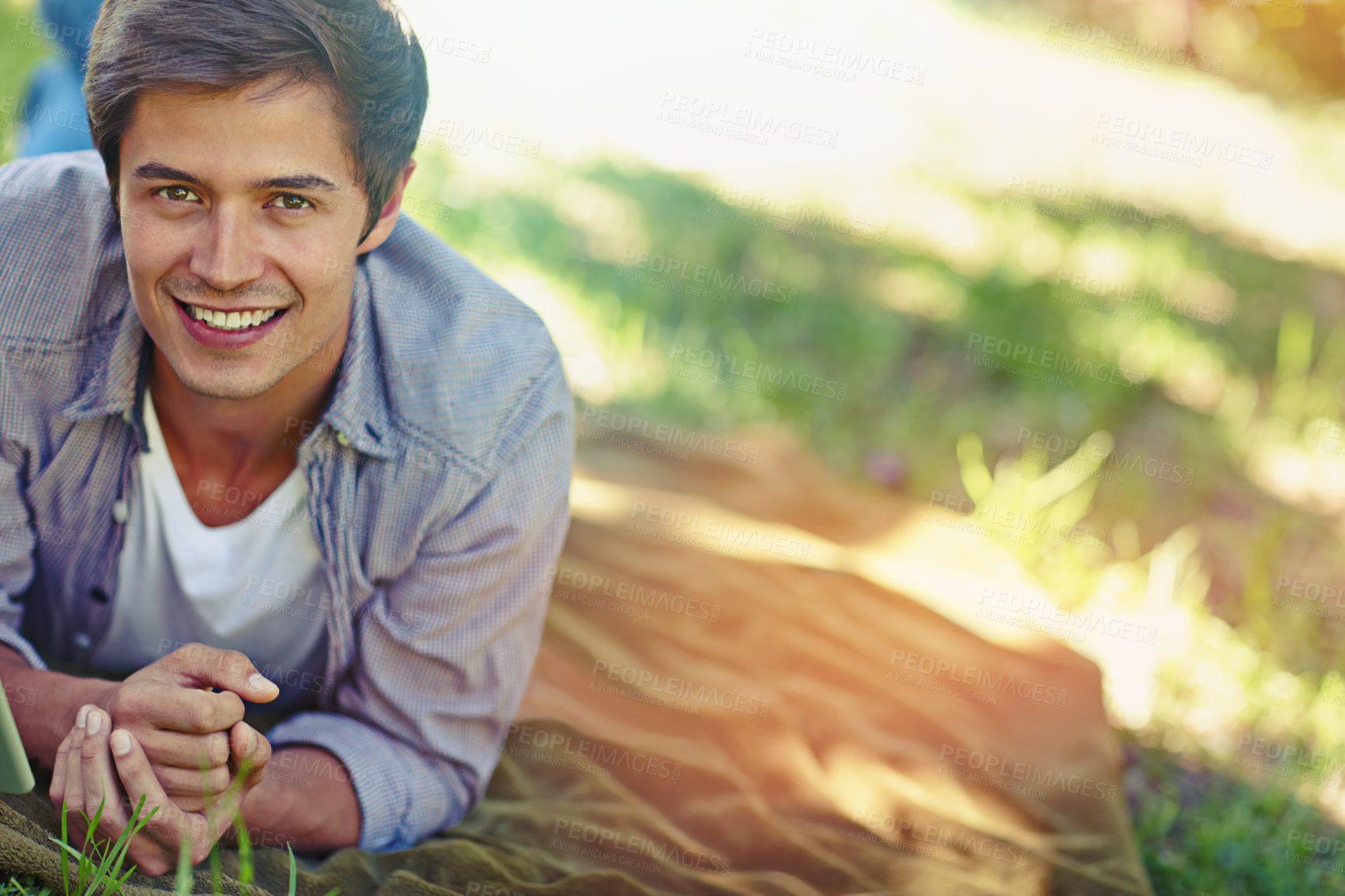 Buy stock photo Man, relax and portrait with grass in nature for outdoor adventure, peace and summer holiday. Male person, happy and face with smile in park for weekend trip, travel and vacation in New Zealand