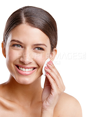 Buy stock photo Studio shot of a beautiful young woman cleansing her face with a cotton pad