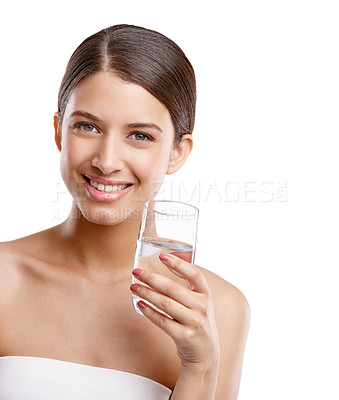 Buy stock photo Studio portrait of a beautiful young woman holding a glass of water against a white background