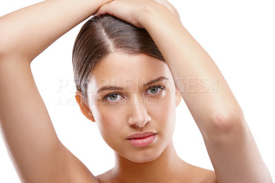 Buy stock photo Studio portrait of a beautiful young woman posing with her arms above her head