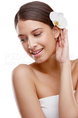 Buy stock photo Studio shot of a beautiful young woman with an orchid in her hair