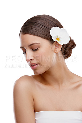 Buy stock photo Studio shot of a beautiful young woman with an orchid in her hair