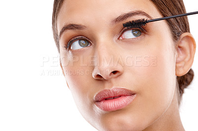 Buy stock photo Closeup studio shot of a beautiful young woman applying mascara