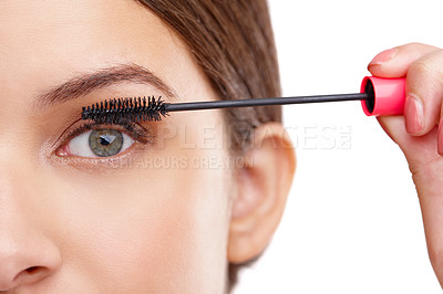Buy stock photo Closeup studio shot of a beautiful young woman applying mascara
