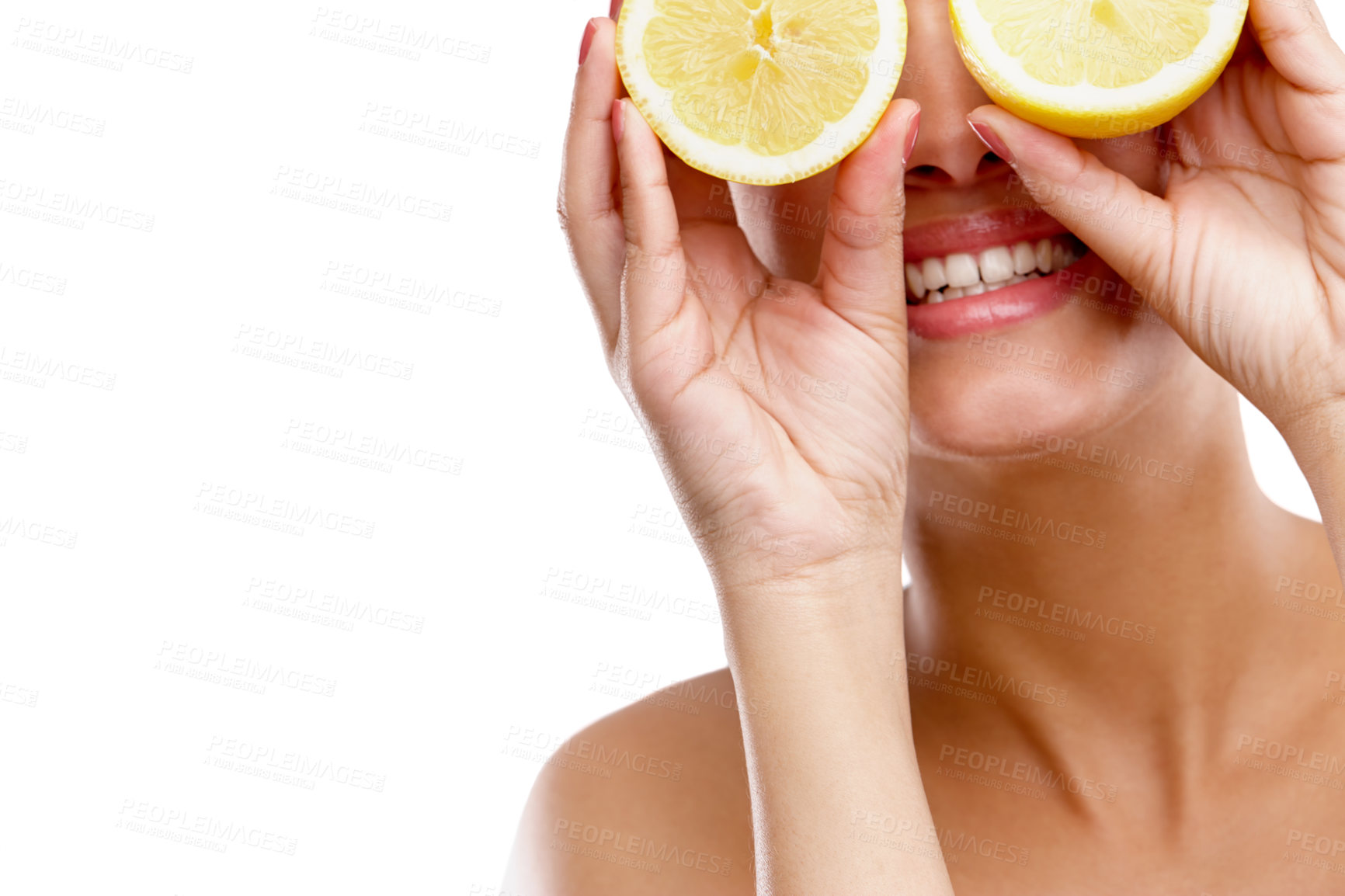 Buy stock photo Studio shot of a young woman holding two halves of a lemon in front of her eyes