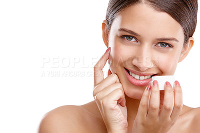 Buy stock photo Studio portrait of a beautiful young woman applying moisturizer to her skin