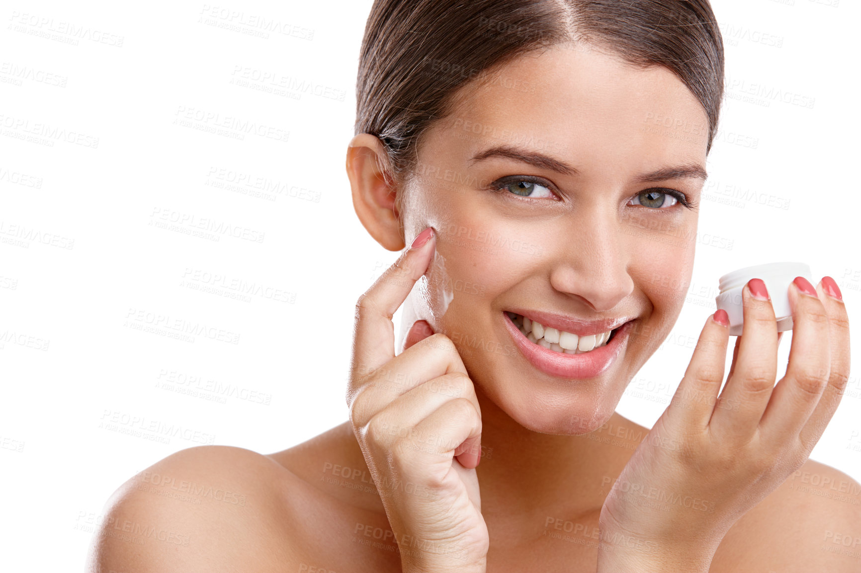 Buy stock photo Studio shot of a beautiful young woman applying moisturizer to her skin