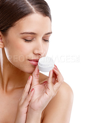 Buy stock photo Studio shot of a beautiful young woman smelling her moisturizer