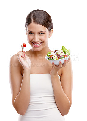 Buy stock photo Portrait of a beautiful young woman standing with a bowl of salad against a white background