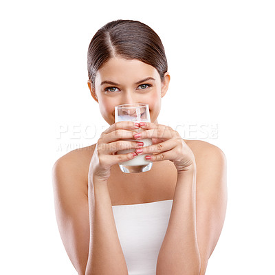 Buy stock photo Studio portrait of an attractive young woman drinking a glass of milk