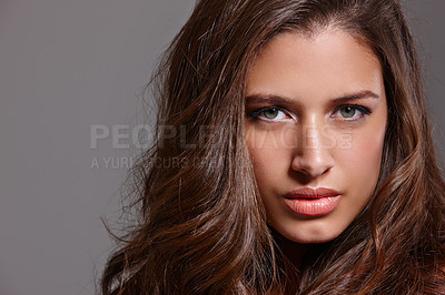 Buy stock photo Cropped portrait of a sensual young woman posing against a gray background