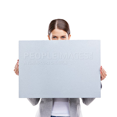 Buy stock photo Studio shot of a beautiful young woman holding a blank placard against a white background
