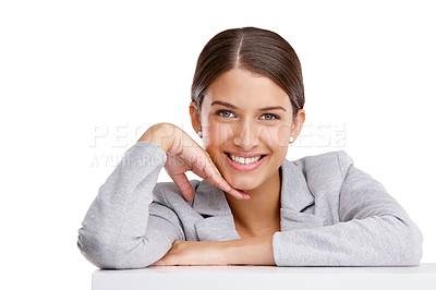 Buy stock photo Studio shot of a beautiful young woman resting on a table against a white background

