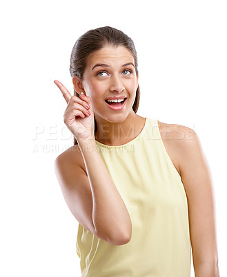 Buy stock photo Studio shot of a beautiful young woman pointing towards something against a white background
