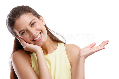 Buy stock photo Studio shot of a beautiful young woman showing you your copyspace against a white background 