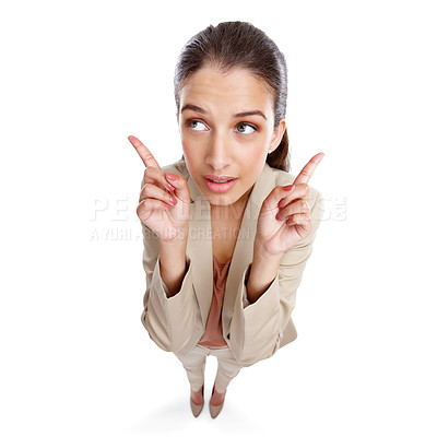 Buy stock photo High angle studio shot of a beautiful young businesswoman pointing towards something against a white background
