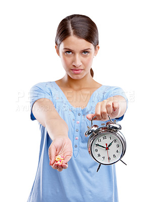 Buy stock photo Medicine, clock and portrait of a patient in a studio waiting to take pills, vitamins or supplements. Tablets, health and young woman with alarm as a medication reminder isolated by white background.