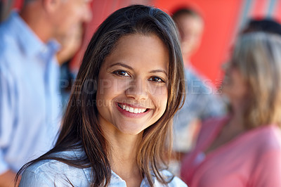 Buy stock photo Shot of a confident young woman standing in front of her colleagues in a casual office environment