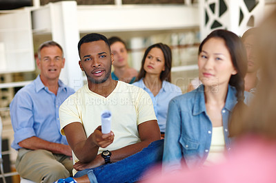 Buy stock photo Shot of man asking a question during a presentation at work