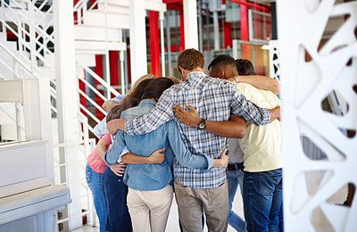 Buy stock photo Shot of a group of coworkers huddled together at the office