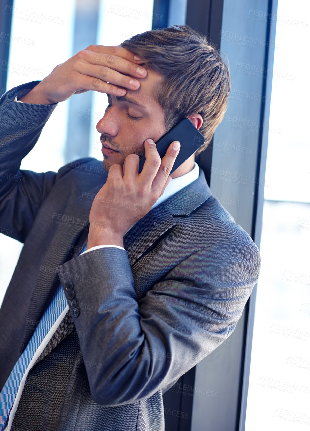 Buy stock photo Shot of a handsome young businessman talking on his mobile phone at work